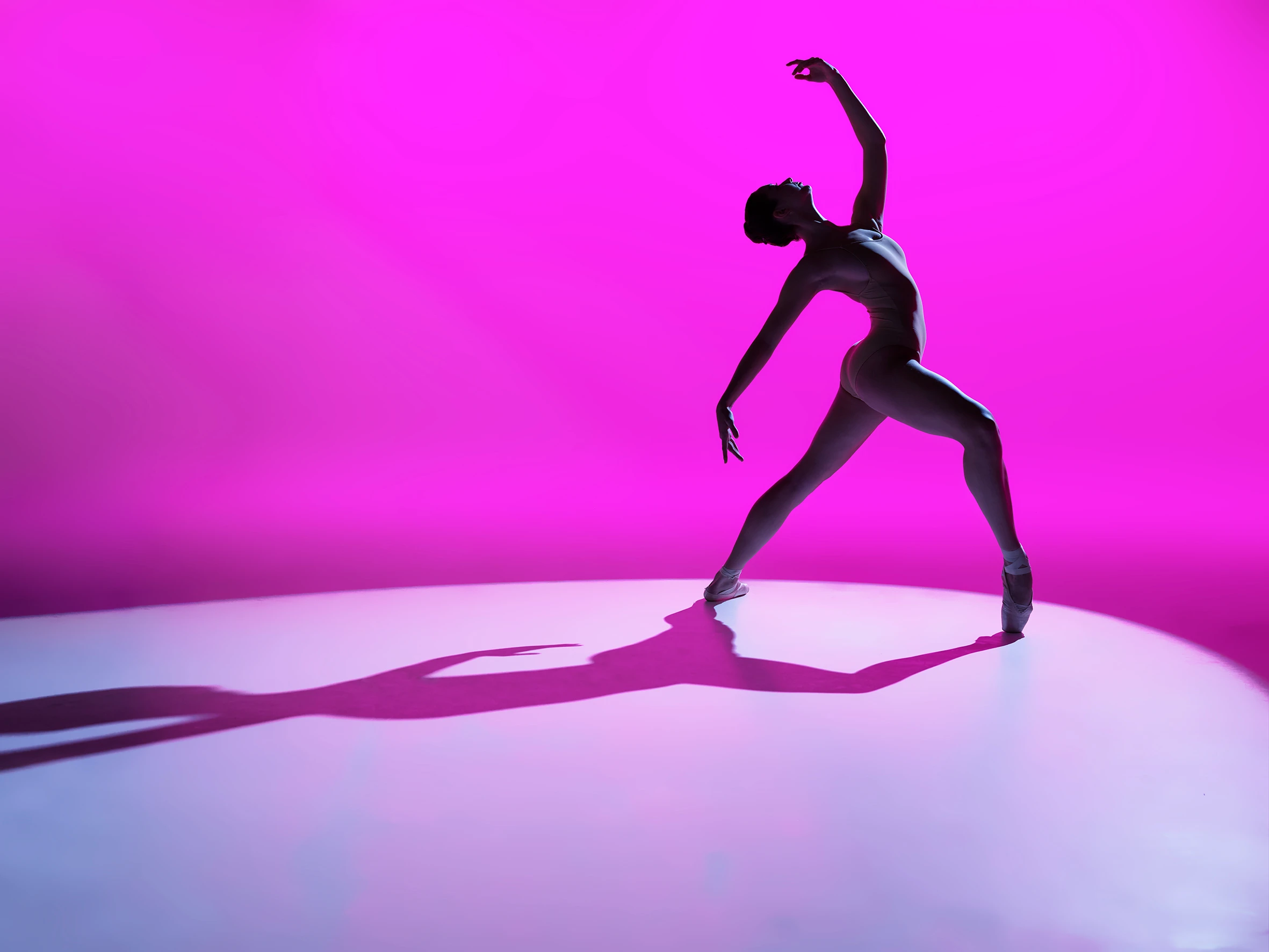 ballerina dancing with pink background