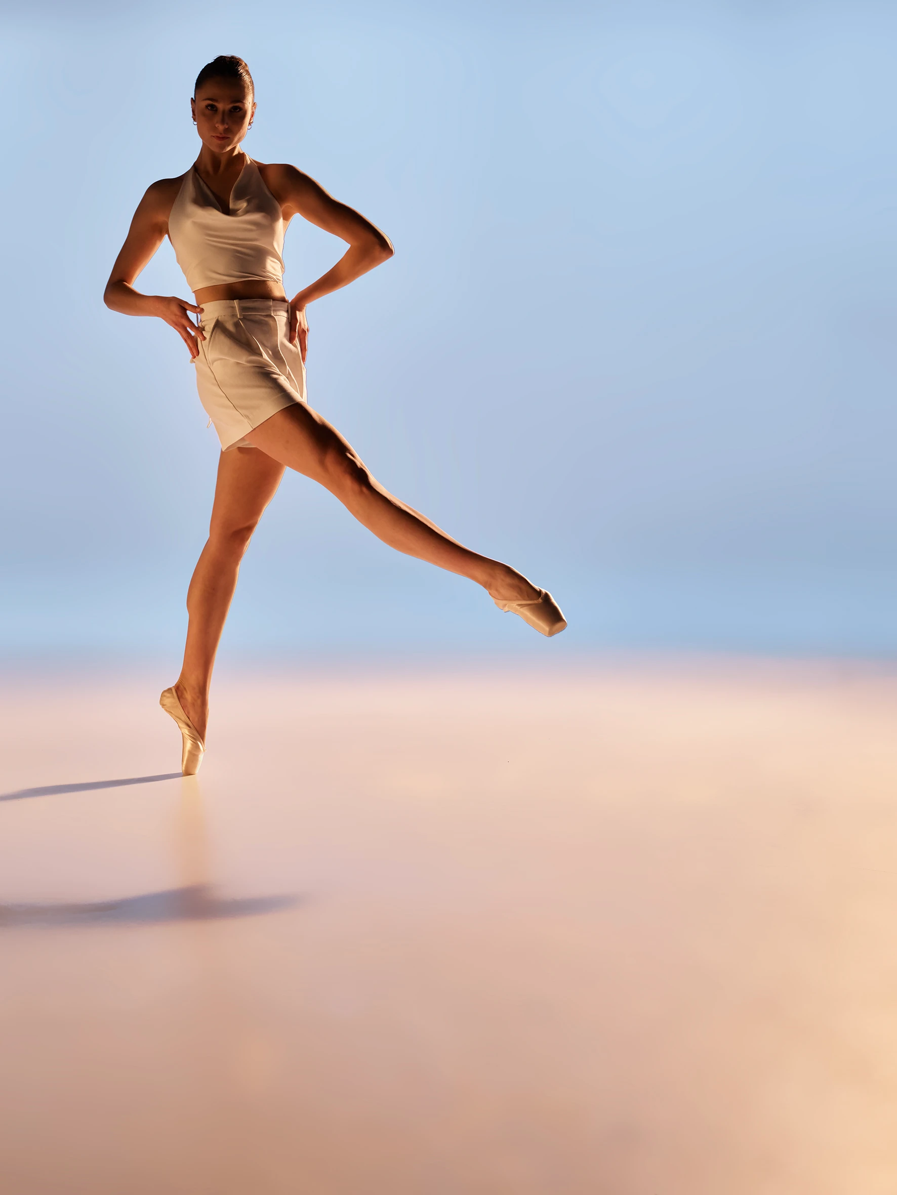 ballerina standing on a beach like scene